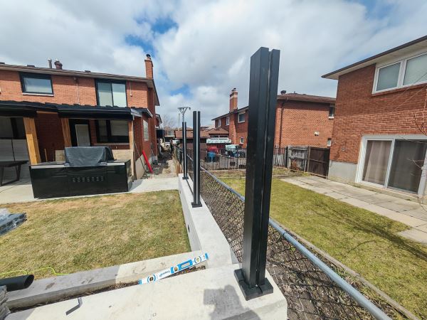 Heavy-duty WPC fence post base plate installation on concrete